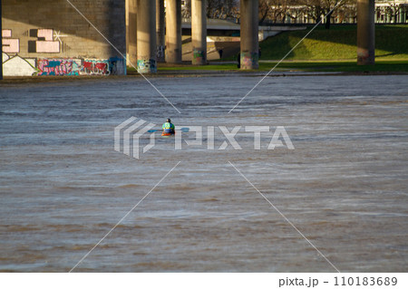A man kayaks on the Rhine river in Dusseldorf A man kayaks on the Rhine river in Dusseldorf 110183689