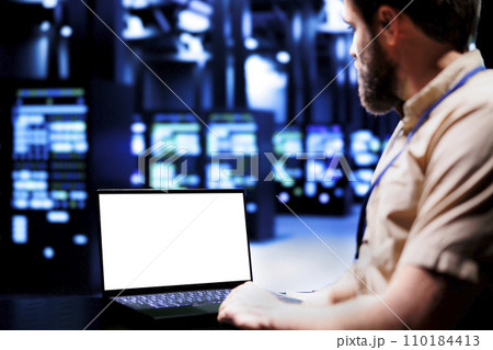 Expert using mock up laptop to evaluate supercomputers with high computing power enabling server room to support demanding applications, including virtual reality and video rendering workloads 110184413