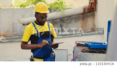 Proficient expert doing leak checks and other necessary repairs to prevent major breakdowns. Knowledgeable professional verifying hvac system, writing findings on clipboard 110184416