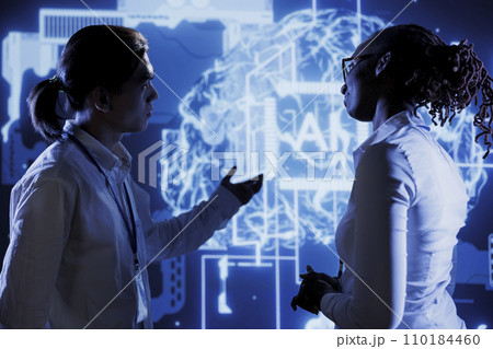 Coworkers brainstorming ways to use AI cognitive computing to extract usable information from complex data. Colleagues implementing artificial intelligence to process massive datasets Coworkers brainstorming ways to use AI cognitive computing to extract usable information from complex data. Colleagues implementing artificial intelligence to process massive datasets 110184460