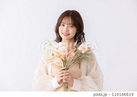 ドライフラワーの花束を持つワンピースの女性 110186619