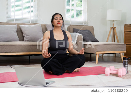 Cheerful attractive young overweight woman in activewear choosing healthy lifestyle Cheerful attractive young overweight woman in activewear choosing healthy lifestyle 110188290