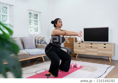 Cheerful attractive young overweight woman in activewear choosing healthy lifestyle Cheerful attractive young overweight woman in activewear choosing healthy lifestyle 110188292