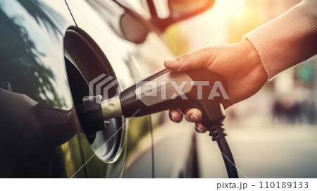 the hand of a man charging an electric car the hand of a man charging an electric car 110189133