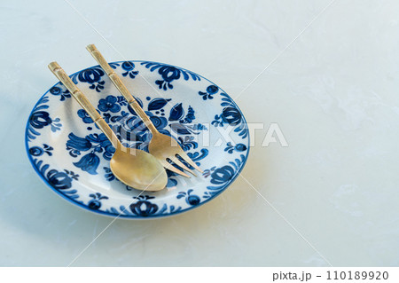beautiful vintage porcelain plate on white table beautiful vintage porcelain plate on white table 110189920