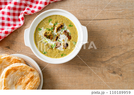 Afghani chicken in green masala curry or Hariyali tikka chicken hara masala with roti or naan bread Afghani chicken in green masala curry or Hariyali tikka chicken hara masala with roti or naan bread 110189959