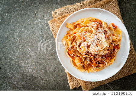 Homemade pasta fettuccine bolognese with cheese Homemade pasta fettuccine bolognese with cheese 110190116