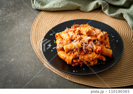 Rigatoni pasta bolognese with cheese Rigatoni pasta bolognese with cheese 110190365