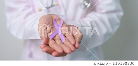 Doctor with purple ribbon for world cancer day, lupus, Pancreatic, Esophageal, Testicular cancer, world Alzheimer, epilepsy, Sarcoidosis, Fibromyalgia and domestic violence Awareness month concepts 110190530