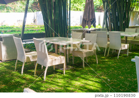 empty wicker table and chair in outdoor restaurant empty wicker table and chair in outdoor restaurant 110190830