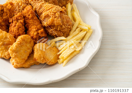 fried chicken with french fries and nuggets on plate fried chicken with french fries and nuggets on plate 110191337