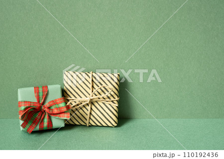 Gift boxes on table. green wall background. copy space Gift boxes on table. green wall background. copy space 110192436