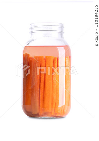 Carrot sticks, homemade fermented carrots, in a glass jar. Carrots cut into sticks and fermented by lactic acid bacteria. Unpasteurized and uncooked they provide probiotics and improve digestion. 110194235