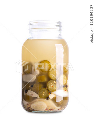 Garlic cucumbers, homemade and fermented in a glass jar. Sliced cucumbers and garlic cloves fermented by lactic acid bacteria. Unpasteurized and uncooked they provide probiotics and improve digestion. 110194237