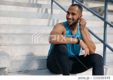 Young man in sportswear on the stairs after a good workout 110200349