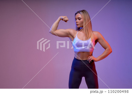 strong woman showing her muscles 110200498