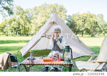 キャンプを楽しむシニア女性 キャンプを楽しむシニア女性 110202549