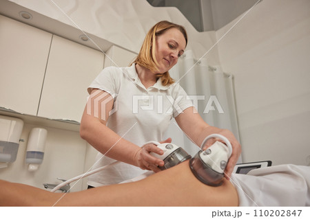 Vacuum massage, beauty centre, medical procedures. Vacuum body massage can help reduce fat in problem areas, slimming of problem areas, special body care equipment for slimming, lpg massage procedure Vacuum massage, beauty centre, medical procedures. Vacuum body massage can help reduce fat in problem areas, slimming of problem areas, special body care equipment for slimming, lpg massage procedure 110202847