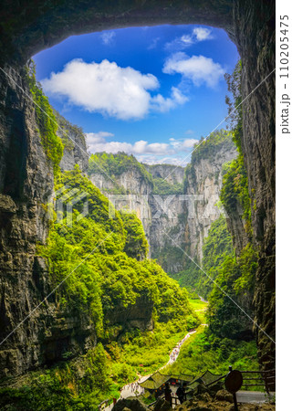 The sky is a natural opening in the roof of the rock pit. Lush green valleys. The sky is a natural opening in the roof of the rock pit. Lush green valleys. 110205475