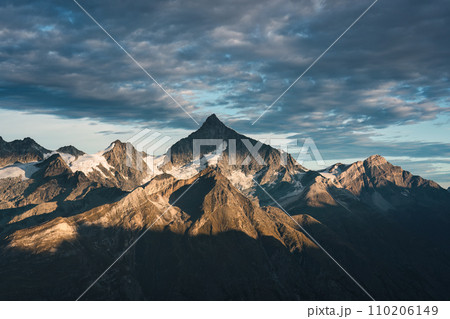 Rocky mountain with cloudy sky on summit in Swiss Alps Rocky mountain with cloudy sky on summit in Swiss Alps 110206149