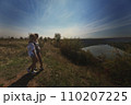 two best friends take a break from work, feel free and enjoy privacy. Blonde sisters in nature look at the landscape. Summer and good weather. High quality photo 110207225