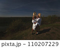 two best friends take a break from work, feel free and enjoy privacy. Blonde sisters in nature look at the landscape. Summer and good weather. High quality photo 110207229