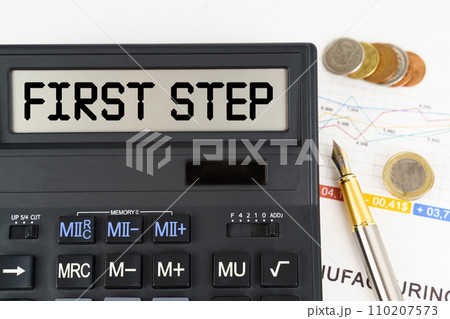 On the table are financial reports, coins and a calculator with the inscription - First Step 110207573