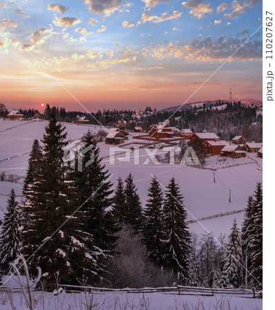 Small and quiet alpine village and winter sunrise snowy mountains around, Voronenko, Carpathian, Ukraine. 110207627