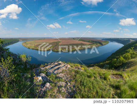 Amazing spring view on the Dnister River Canyon with picturesque rocks, fields, flowers. This place named Shyshkovi Gorby, Nahoriany, Chernivtsi region, Ukraine. Amazing spring view on the Dnister River Canyon with picturesque rocks, fields, flowers. This place named Shyshkovi Gorby, Nahoriany, Chernivtsi region, Ukraine. 110207965