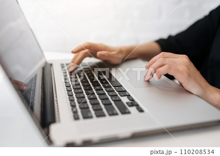 Close up woman's hands typing on laptop keyboard at home office. Businesswoman or student girl using pc for online internet marketing, freelance, work from home, education online, distance studying Close up woman's hands typing on laptop keyboard at home office. Businesswoman or student girl using pc for online internet marketing, freelance, work from home, education online, distance studying 110208534