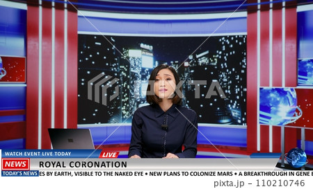 TV broadcaster talks about royal coronation and presents important event followed by people worldwide. Asian presenter going live on tv program to introduce new king, late night monarchy news. 110210746