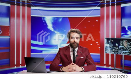 Media journalist talks about news segment on live television, addressing everyday important topics for advertisement. Man reporter presenting breaking news on tv program, doing newscast. 110210769