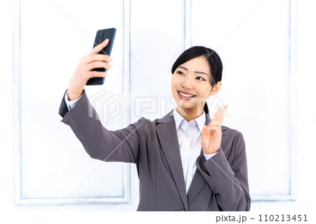 スマホを手にしたキャリア女性 スマホを手にしたキャリア女性 110213451
