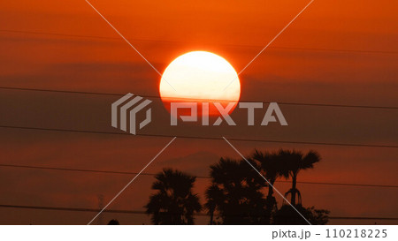 Beautiful nature morning with orange, yellow sunshine and fluffy clouds. Time lapse of a beautiful dramatic sky with a big sun at sunrise. Beautiful nature morning with orange, yellow sunshine and fluffy clouds. Time lapse of a beautiful dramatic sky with a big sun at sunrise. 110218225