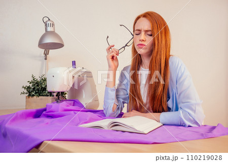 creative seamstress redhaired woman in workplace studio.small business concept. creative seamstress redhaired woman in workplace studio.small business concept. 110219028