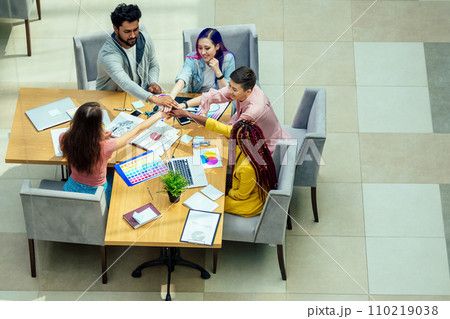 mixed-race journalist fashion designers working together in a bright office 110219038