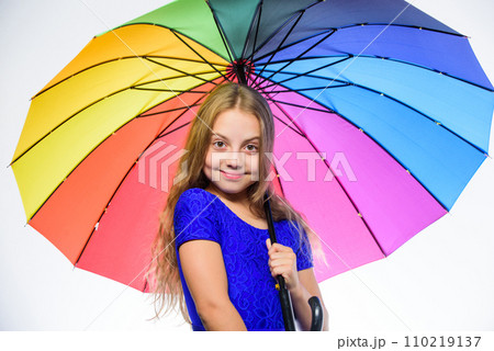 Feeling protected at this autumn day. Happy childhood. School time. Happy little girl with umbrella. Small girl with umbrella in rainy weather. Autumn fashion. Child. Feeling protected at rainy day 110219137