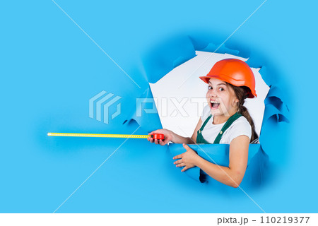 measuring the height. architect. playing with tools. growing concept. little girl with measuring tape. instruments for renovation apartment. childhood happiness and development. copy space 110219377