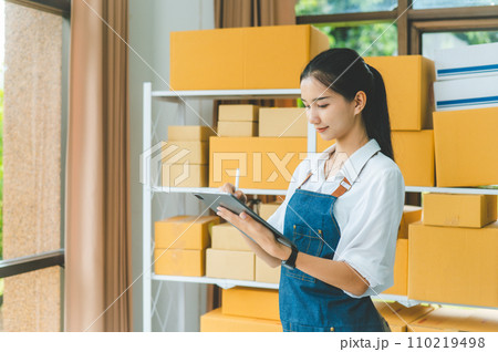 Small business owners online check stock on shelves, to calculate costs or check products for customers.concept shopping online Small business owners online check stock on shelves, to calculate costs or check products for customers.concept shopping online 110219498