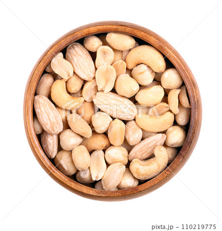 Mixed nuts, roasted and salted nut mix, in a wooden bowl. Snack food, consisting of peanuts, hazelnuts, cashews, and blanched almonds. Close-up, from above, isolated over white, macro food photo. Mixed nuts, roasted and salted nut mix, in a wooden bowl. Snack food, consisting of peanuts, hazelnuts, cashews, and blanched almonds. Close-up, from above, isolated over white, macro food photo. 110219775