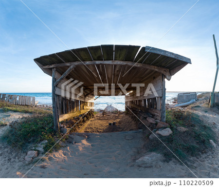 Wooden Boathouse and Rails at Sunset on Secluded Beach Wooden Boathouse and Rails at Sunset on Secluded Beach 110220509