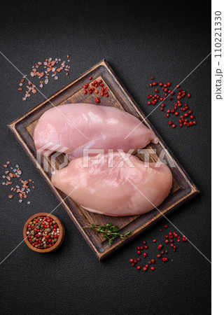 Fresh chicken fillet on a dark concrete table with spices and herbs 110221330