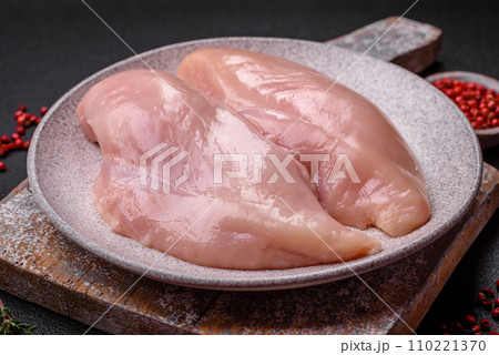 Fresh chicken fillet on a dark concrete table with spices and herbs 110221370