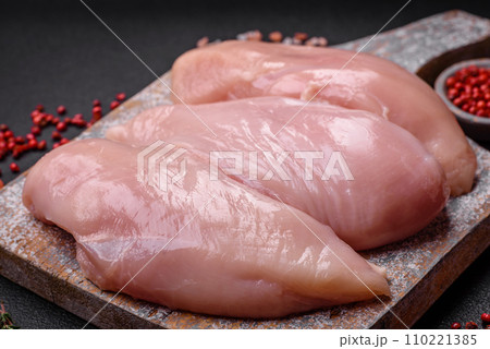 Fresh chicken fillet on a dark concrete table with spices and herbs 110221385