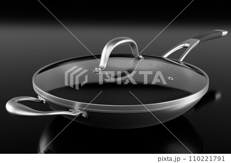 Stainless steel frying pan with glass lid and chrome cookware on black 110221791