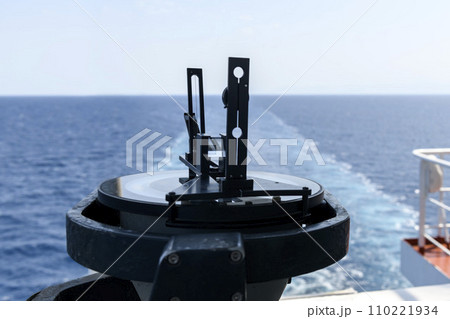 Azimuth ring on gyro compass. Direction finder on the navigational bridge. Azimuth vane. Bearing finder. Navigational equipment. Azimuth ring on gyro compass. Direction finder on the navigational bridge. Azimuth vane. Bearing finder. Navigational equipment. 110221934