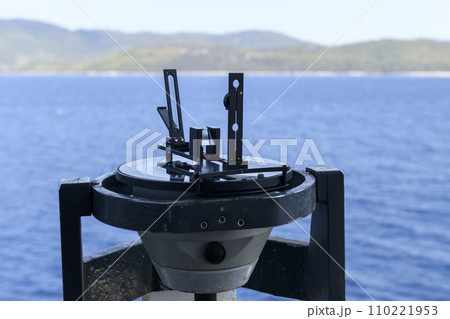 Azimuth ring on gyro compass. Direction finder on the navigational bridge. Azimuth vane. Bearing finder. Navigational equipment. 110221953