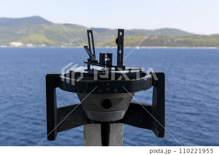 Azimuth ring on gyro compass. Direction finder on the navigational bridge. Azimuth vane. Bearing finder. Navigational equipment. Azimuth ring on gyro compass. Direction finder on the navigational bridge. Azimuth vane. Bearing finder. Navigational equipment. 110221955