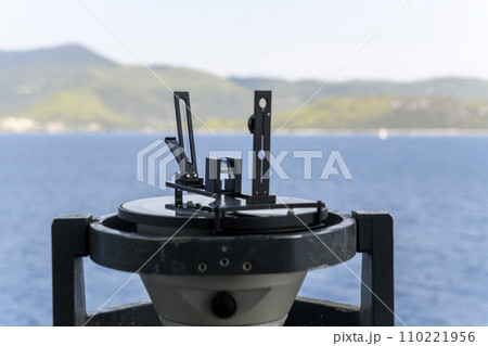 Azimuth ring on gyro compass. Direction finder on the navigational bridge. Azimuth vane. Bearing finder. Navigational equipment. Azimuth ring on gyro compass. Direction finder on the navigational bridge. Azimuth vane. Bearing finder. Navigational equipment. 110221956