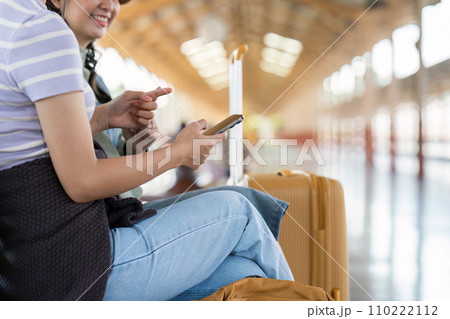 Woman using mobile phone while travel by train. travel concept Woman using mobile phone while travel by train. travel concept 110222112